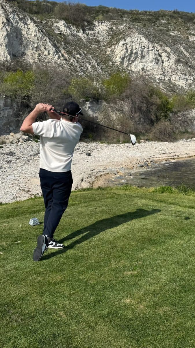Dominik teeing off on the golf course